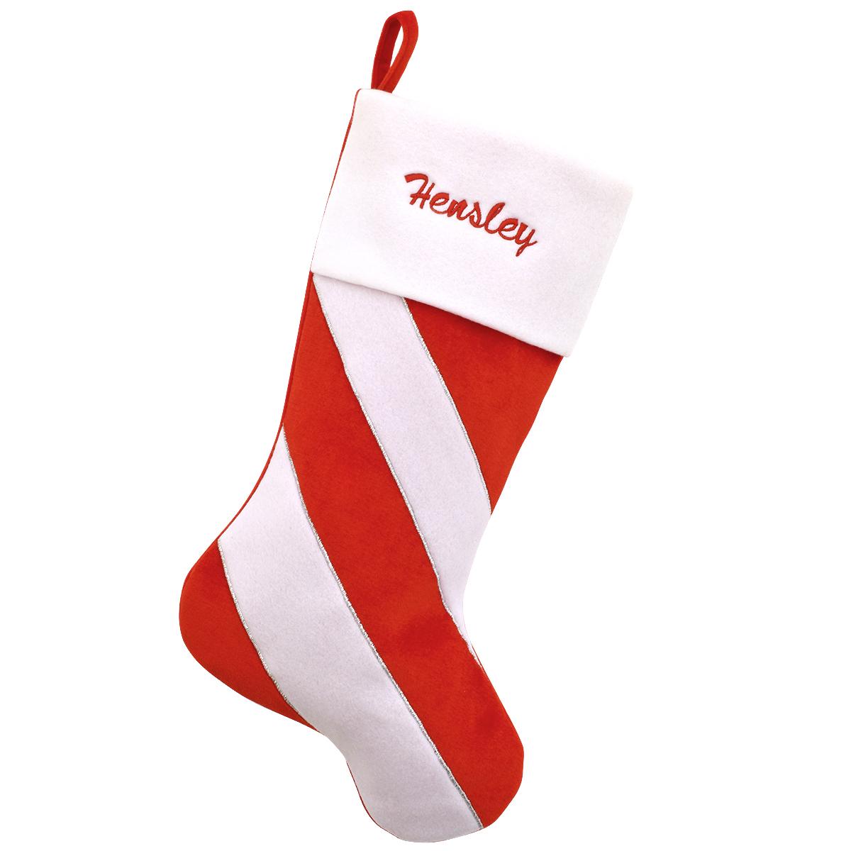 Red and white candy cane striped personalized velvet stocking with white cuff.