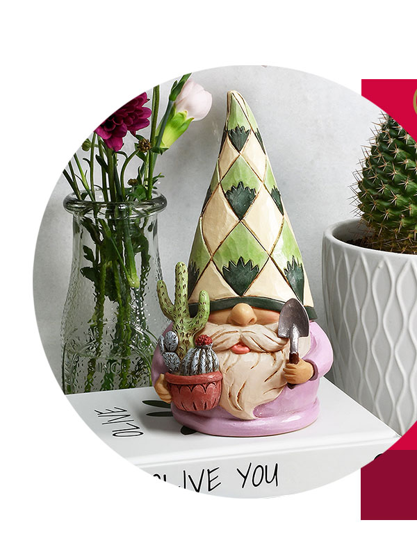 Rooting For You Succulent Gnome Jim Shore Figure paired with some real succulent plants on a shelf