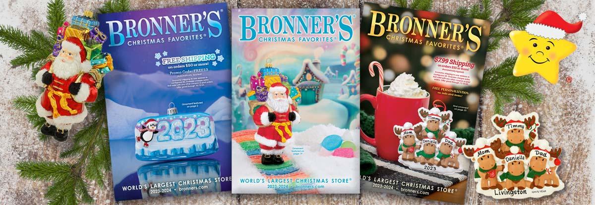 Bronner's Christmas Favorites 2023 Catalogs with Santa carrying presents glass ornament and Moose famlily of 4 resin ornament