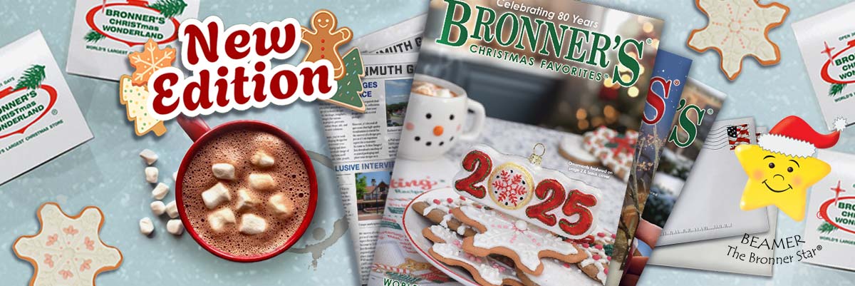 Bronner's Christmas Favorites 2025 Catalogs displayed on a stack of mail and surrounded my Bronner's white gift boxes